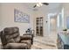 Bright and airy entryway with glass-front bookcase and seating area at 4104 Midnight Crest Ave, North Las Vegas, NV 89031