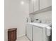 Bright laundry room with washer, dryer, and cabinets at 4104 Midnight Crest Ave, North Las Vegas, NV 89031
