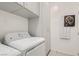 Functional laundry room, washer, dryer and storage cabinets at 4104 Midnight Crest Ave, North Las Vegas, NV 89031