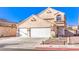 Two-story house with a two-car garage, front yard landscaping, and a home sign at 4125 Glenfield Cir, Las Vegas, NV 89129