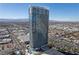 Aerial view of a modern highrise building with pool and surrounding cityscape at 4381 W Flamingo Rd # 2306, Las Vegas, NV 89103