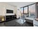 Modern living room with city views, large screen TV, and comfortable seating at 4381 W Flamingo Rd # 2306, Las Vegas, NV 89103
