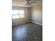 Bright bedroom with gray laminate flooring and ceiling fan at 4745 E Flamingo Rd, Las Vegas, NV 89121