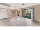 Bright living room with tile floor, sliding glass door to patio, and adjacent kitchen at 4872 Nara Vista Way # 101, Las Vegas, NV 89103