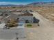 Aerial view of house, street, and neighborhood with mountain backdrop at 5130 Valero Ct, Pahrump, NV 89060