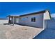 New home with covered patio, gray exterior, and a gravel backyard at 5130 Valero Ct, Pahrump, NV 89060