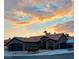 Single story house with a brown exterior, tile roof and landscaped front yard at sunset at 5445 Rose Hills St, Las Vegas, NV 89149