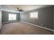 Well-lit bedroom featuring gray walls, carpeting, and a ceiling fan at 6215 Newville Ave, Las Vegas, NV 89103