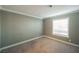 Simple bedroom with gray walls, carpet, and a window with blinds at 6215 Newville Ave, Las Vegas, NV 89103