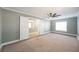 Large bedroom with gray walls, carpet, and access to another room at 6215 Newville Ave, Las Vegas, NV 89103