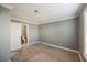 Spacious bedroom with grey walls and carpeting, featuring an ensuite bathroom at 6215 Newville Ave, Las Vegas, NV 89103