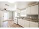 Modern kitchen with white cabinets and granite countertops at 6215 Newville Ave, Las Vegas, NV 89103