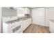 Bright kitchen features white cabinets, granite countertops, and modern appliances at 6215 Newville Ave, Las Vegas, NV 89103