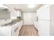 Modern white kitchen with granite countertops and stainless steel appliances at 6215 Newville Ave, Las Vegas, NV 89103