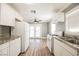 White kitchen with granite counters and stainless steel appliances at 6215 Newville Ave, Las Vegas, NV 89103