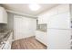 Modern kitchen with white appliances, granite counters, and ample cabinet space at 6215 Newville Ave, Las Vegas, NV 89103