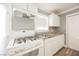 Renovated kitchen with white cabinets, granite countertops, and a gas range at 6215 Newville Ave, Las Vegas, NV 89103