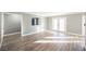 Sunlit living room featuring hardwood floors and access to backyard at 6215 Newville Ave, Las Vegas, NV 89103