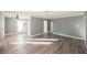 Open concept living area with hardwood floors and kitchen access at 6215 Newville Ave, Las Vegas, NV 89103