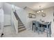 Dining area with gray table and chairs, staircase visible at 6276 Point Isabel Way, Las Vegas, NV 89122