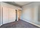 Spacious bedroom with gray walls, gray carpet, and a large closet at 6401 Home Run Dr, Las Vegas, NV 89130