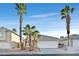 Single-story house with a two-car garage and palm trees at 6505 Moon Roses Ct, Las Vegas, NV 89108