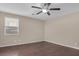 Bedroom with wood floors, ceiling fan, and neutral wall colors at 7154 Flowering Rose Ave, Las Vegas, NV 89117