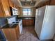 Kitchen with linoleum flooring, wood cabinets, and white appliances at 7200 Pirates Cove Rd # 2005, Las Vegas, NV 89145
