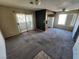 View of a carpeted living room with sliding glass doors to the outside at 7200 Pirates Cove Rd # 2005, Las Vegas, NV 89145