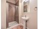 Clean bathroom with pedestal sink and updated shower at 7642 Riva Ridge St, Las Vegas, NV 89149