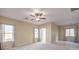 Well-lit bedroom with ceiling fan and ample closet space at 7642 Riva Ridge St, Las Vegas, NV 89149