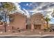 Rear view of two story house with desert landscaping at 7642 Riva Ridge St, Las Vegas, NV 89149