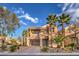 Two-story house with a large driveway and palm trees in front at 7642 Riva Ridge St, Las Vegas, NV 89149