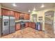 Updated kitchen featuring dark wood cabinets and stainless steel appliances at 7642 Riva Ridge St, Las Vegas, NV 89149