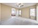 Bright main bedroom with ceiling fan, large windows, and ensuite bathroom at 7642 Riva Ridge St, Las Vegas, NV 89149