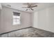 Spacious bedroom with a ceiling fan and grey carpet at 826 N Water St, Henderson, NV 89011