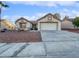 Single-story house with a two-car garage and desert landscaping at 8509 Goodhaven Dr, Las Vegas, NV 89134
