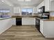 Kitchen with white cabinets, granite countertops, and black appliances at 8509 Goodhaven Dr, Las Vegas, NV 89134