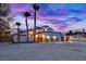 Stunning curb appeal at dusk. Two story home with palm trees and modern exterior at 8645 Edmond St, Las Vegas, NV 89139