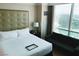 Bright bedroom with king bed, sofa, and golf course view at , Las Vegas, NV 89109