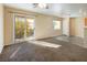 Spacious living area with laminate floor and access to balcony at 10516 Blanca Peak Ave, Las Vegas, NV 89129