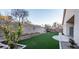 Landscaped backyard with artificial turf and a block wall at 1240 Honey Lake St, Las Vegas, NV 89110