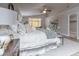 Main bedroom with a king-size bed, and neutral color palette, and a sitting area at 1240 Honey Lake St, Las Vegas, NV 89110