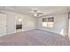 Large bedroom featuring plush carpets, a ceiling fan, and abundant natural light at 2694 Marvel Astoria St, Henderson, NV 89044