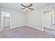 Bedroom with carpeted floors, ceiling fan, and closet entryways at 2694 Marvel Astoria St, Henderson, NV 89044