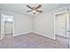 Comfortable bedroom with ceiling fan, carpet flooring, and access to closet at 2694 Marvel Astoria St, Henderson, NV 89044