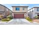Two-story home featuring a two-car garage, neutral colored stucco, and stone accents at 2694 Marvel Astoria St, Henderson, NV 89044