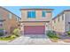 Attached garage with burgundy door and landscaping at 2694 Marvel Astoria St, Henderson, NV 89044