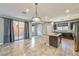 Open-concept kitchen with an island, access to outdoor patio, stainless steel appliances and neutral walls at 2694 Marvel Astoria St, Henderson, NV 89044