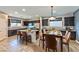 Well-appointed kitchen with dark cabinets, granite countertops, stainless appliances and dining table at 2694 Marvel Astoria St, Henderson, NV 89044